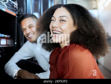 Portrait, black woman and information technology, server and happy worker, funny conversation and teamwork in IT. Computer engineer, woman and man Stock Photo