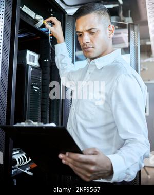 Server room, database and IT support with a man programmer working on an information storage solution. Documents, cybersecurity and cloud computing Stock Photo