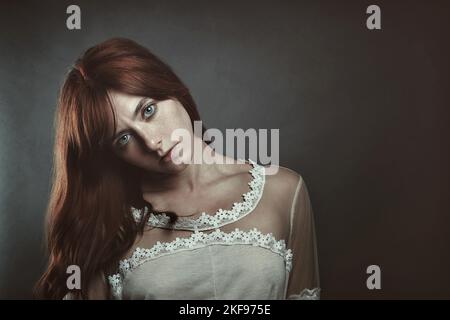 Portrait of a red haired vampire woman. Gothic and mysterious Stock Photo
