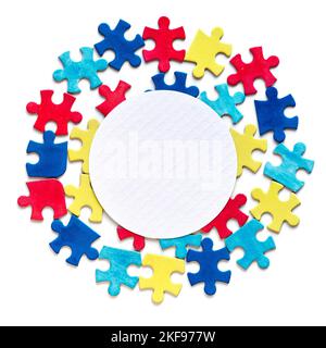 Autism World Awareness Day. Copy-space, place for text on white paper circle framed with puzzle pieces. Autism awareness symbol, mosaic elements on Stock Photo