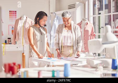 Teamwork, collaboration and fashion designer team working on a new collection, planning and sharing vision in a design studio. Partnership, women and Stock Photo