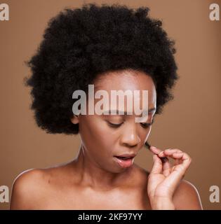 Face, hair and split ends with a model black woman in studio on a brown background with haircare issues. Stress, salon and hair care with an Stock Photo