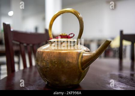 A large copper kettle used when adding water to copper pot shabu-shabu Stock Photo