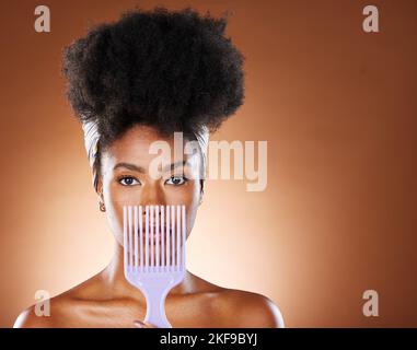 Black woman, hair care beauty or model with afro comb in brown studio background portrait. Health salon, wellness or African American girl and face Stock Photo