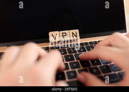 Internet user works on laptop with VPN Virtual Private Network for secure and encrypted connection. Stock Photo