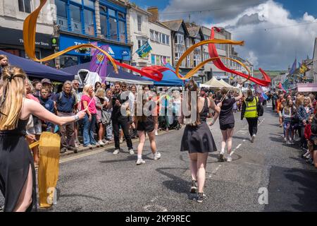 School students ribbon dancing in the Mazey Day parade celebrations as part of the Golowan Festival in Penzance in Cornwall in the UK. Stock Photo