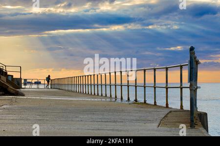 Woman on pier in Cromer. Stock Photo