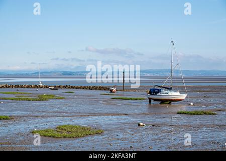 Boat in mud at low tide, Morecambe Bay, Lancashire Stock Photo