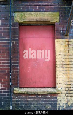 Boarded up window in old building Stock Photo