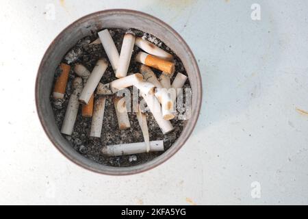 Close up burning cigarette in ashtray on table  Stock Photo