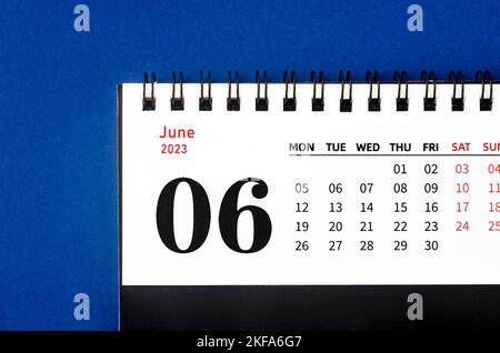 June 2023 Monthly desk calendar for 2023 year on blue background.