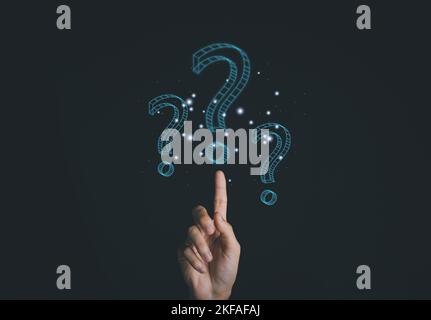 Businessman hand touch question mark symbol with hologram on hand of man. Thinking Concept. Stock Photo