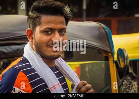 Delhi - Indian auto rickshaw three wheeler tempo, taxi driver man Stock Photo