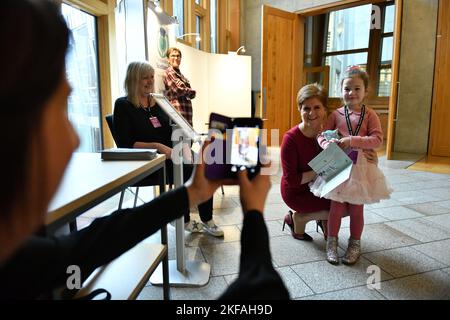 Edinburgh, Scotland, UK. 17 November 2022. PICTURED: Ava, 6, who is celebrating her 6th birthday today seen meeting seen meeting Nicola Sturgeon MSP, First Minister of Scotland and Leader of the Scottish National Party (SNP). Ava wanted to come and meet the First Minister again after she last saw the First Minister during the council elections in Kirkcaldy spending the afternoon with her during campaigning. Scenes inside the weekly session of First Ministers Questions inside the Scottish Parliament at Holyrood. Scenes showing before, during and after FMQs. Credit: Colin D Fisher Stock Photo