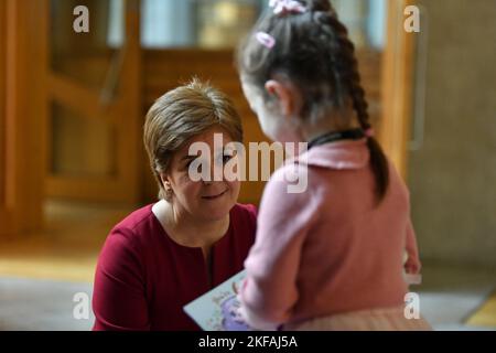 Edinburgh, Scotland, UK. 17 November 2022. PICTURED: Ava, 6, who is celebrating her 6th birthday today seen meeting seen meeting Nicola Sturgeon MSP, First Minister of Scotland and Leader of the Scottish National Party (SNP). Ava wanted to come and meet the First Minister again after she last saw the First Minister during the council elections in Kirkcaldy spending the afternoon with her during campaigning. Scenes inside the weekly session of First Ministers Questions inside the Scottish Parliament at Holyrood. Scenes showing before, during and after FMQs. Credit: Colin D Fisher Stock Photo