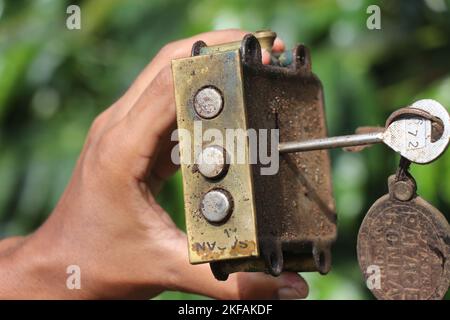 Used Door lock with double lock system held in hand with keys Stock Photo