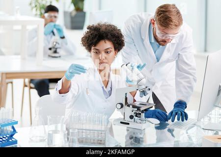 team of research scientists conducts research in a modern laboratory Stock Photo