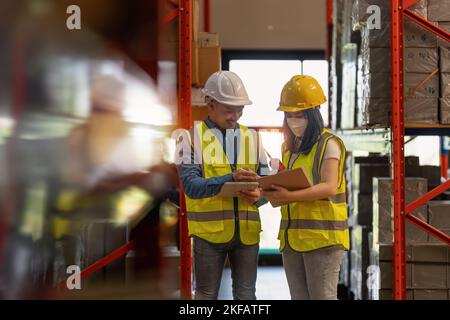 Working at warehouse. Male warehouse worker checking in storage department. Employee organizing goods distribution to the market. Stock Photo