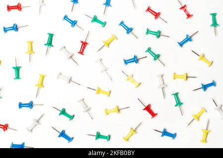 Lot of colored pushpins on a white background Stock Photo