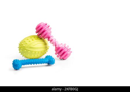 Colored dog toys on a white background with copy space Stock Photo