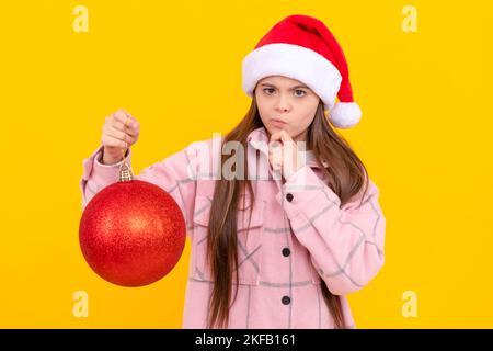 child wearing warm clothes. happy new year. merry christmas. serious kid in santa claus hat. Stock Photo