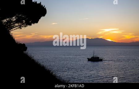 Fishing and pleasure boats at sunset in the Aegean sea in summer in Greece Stock Photo