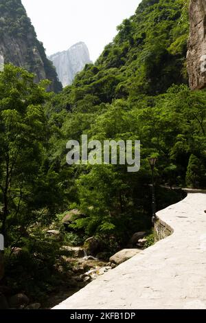 Huashan Yu (Huashan Gorge) seen after departing from the Yuquanyuan Temple (west gate entrance). Views and landscape scene from the hiking trail path to the five peaks of  Huashan Mountain / Mount Hua / Mt Hua near Huayin, Weinan, China 714299 (125) Stock Photo