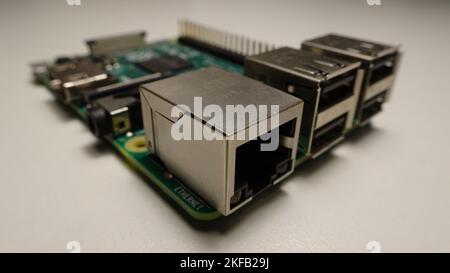 A closeup of a Raspberry Pi on a white surface Stock Photo