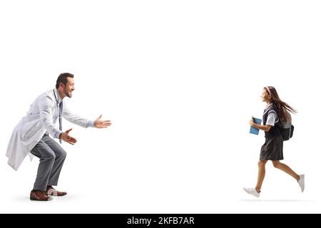 Schoolgirl running towards a male doctor isolated on white background Stock Photo