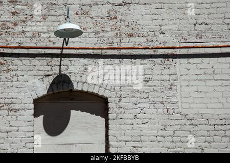 Brick wall with a lamp and copy space Stock Photo