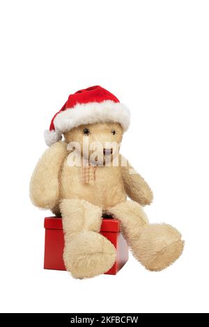 teddy bear sitting on a gift package isolated on white background Stock Photo