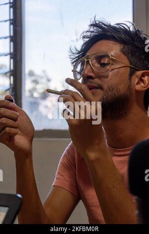 young gay homosexual man founding a cigar, mexico latin america Stock Photo