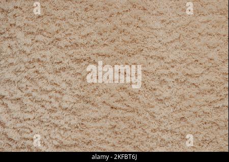 Beige color cloth carpet background. Soft seamless warm fleece carpet Stock Photo