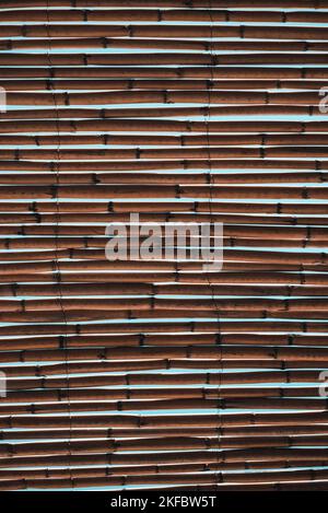 Background Of Bamboo Sticks Roof Through Which Can See Sky And Sunlight. Stock Photo