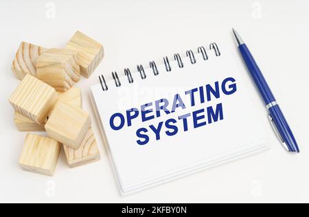 Internet and security concept. On the table are cubes, a pen and a notebook with the inscription - Operating System Stock Photo