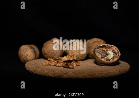 Walnuts on a black matte background. Stock Photo
