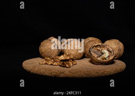 Walnuts on a black matte background. Stock Photo