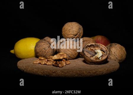Walnuts on a black matte background. Stock Photo