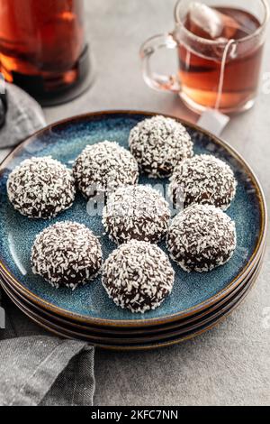 Coconut chocolate balls on plate on the kitchen table. Stock Photo