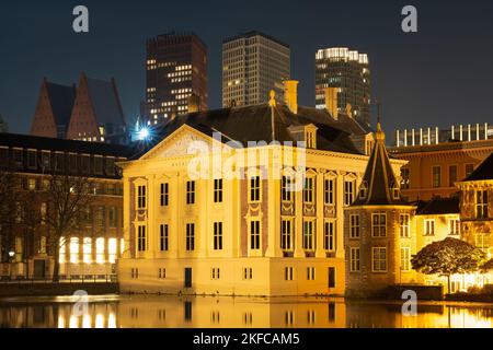 Historical buildings at the Binnenhof complex in The Hague at night, Famous Mauritshuis museum, Hofvijver lake and small octagonal building known as T Stock Photo
