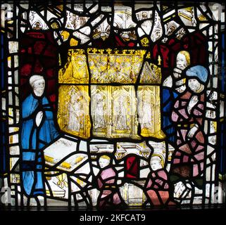 15th Century Stained-glass panel of worshippers at St.Cuthbert's shrine in Durham Cathedral (golden reliquary containing his body), York Minster, York Stock Photo