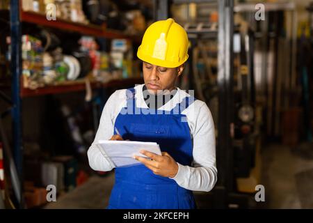 Confident worker taking inventory in building materials store Stock Photo