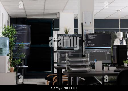 Computer displays on table running programming code html algorithms in empty coding agency room. Database network servers cloud computing in software company, data script language. Stock Photo