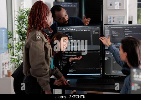 Software programmers analyzing html code and database, brainstorming script ideas to develop new security system. Engineers working with coding language collaborating on group project. Stock Photo