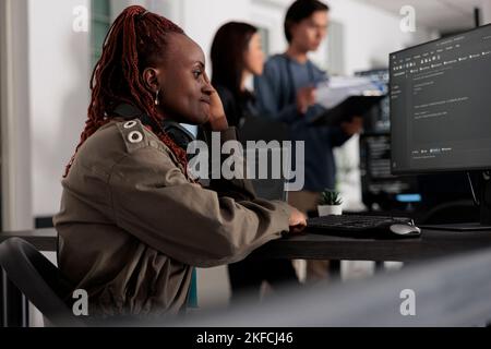 Pensive web developer thinking at software script development, brainstorming ideas to create programming code. It system engineer working at database server in big data company office Stock Photo