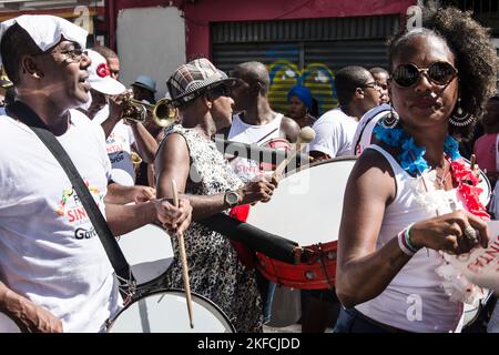 Salvador, Bahia, Brazil - February 08, 2016: People are playing percussion musical instruments during the neighborhood Carnival in the city of Salvado Stock Photo