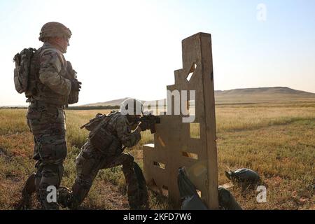 2nd Stryker Brigade Combat Team Soldier shoots a target during the Brigade Stress Shoot Sept 8. at Fort Carson. 1st Battalion 12th Infantry Regiment dominated the range and won the competition. Stock Photo