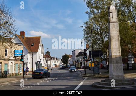 Quiet high street with cars stopped at the traffic lights next the Great Dunmow War Memorial Stock Photo