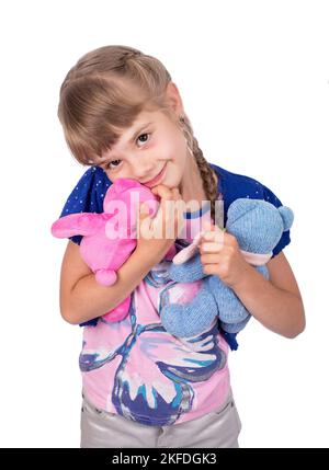 Little girl holding a teddy bear. Isolated on white background. Girl hugging two teddybears. Happy child. Stock Photo
