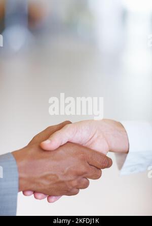 Executives shaking hands with each other. Closeup of two business executives shaking hands with each other. Stock Photo